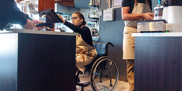 Photo of cashier in a wheelchair